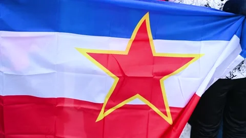 People holding flag of former Yugoslavia. Socialist Federal Republic Stock Footage 231574401