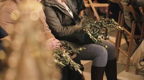 People holding palm branches during the Mass on Palm Sunday. Video stock 62352271
