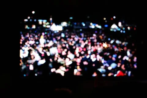 People holding small firework in front of a big screen, waiting new year coming Foto stock