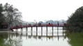 People on the Huc bridge leading to Ngoc Son temple in Hanoi, Vietnam HD Footage
