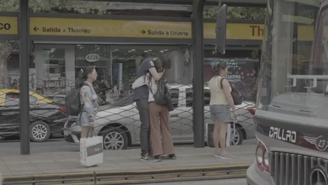 People hugging each other at a bus stop in Buenos Aires, Argentina Stock Footage 345143259