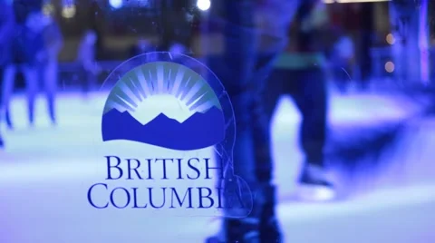 People ice skating, logo of British Columbia on transparent glass Stock Footage 57787299