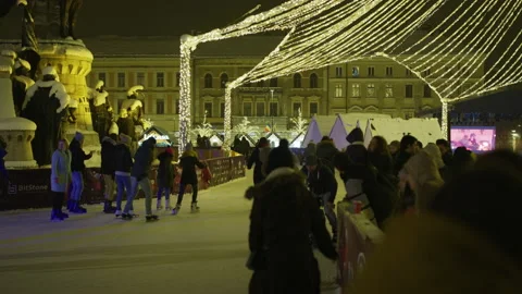 People ice skating in Union Square, Cluj Napoca, at night Stock Footage 217323767