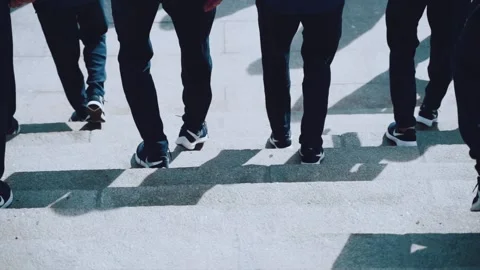People in identical clothes walk down the stairs Stock Footage 153620340