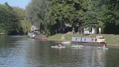 People on inflatable rafts row down the river Cam Stock Footage 91544202
