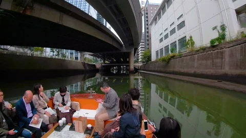 The people inside the boat while cruising the canal in Osaka Japan Stock Footage 129279605