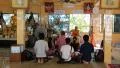 People inside Buddhist temple on Pratumnak Hill by Golden Buddha statue, Pattaya HD Footage