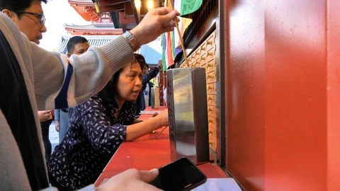 People inside the Senso-ji Temple looking into letters in Tokyo Japan Stock Footage 121385147