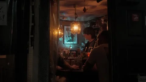 People inside Tokyo bar seen through window Видео 336050950