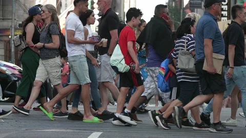 People jam dense intersection slo-mo wheel chair cars taxi legs faces bodies Video stock 202440809