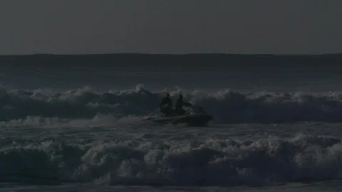 People in jet ski passing between the waves - Slow motion Stock Footage 105344294