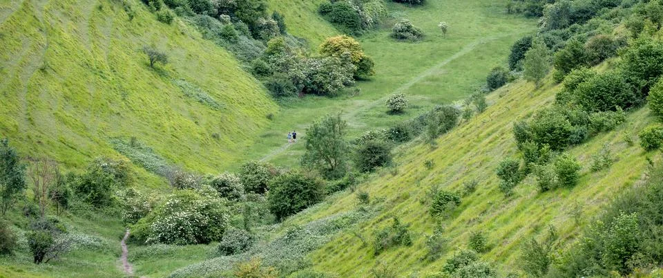 People jogging in The Devil's Kneading Trough which is part of kent downs o.. Stock Photos