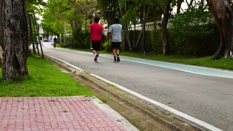 People jogging in the park in the evening Selective focus Stock Footage 171799684