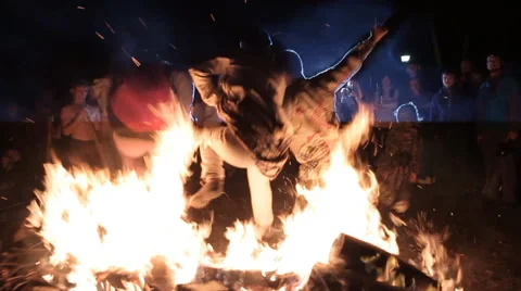 People Jump Over A Large Fire. Slow Motion Stock Footage 53194812