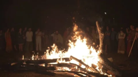 People jump over a large fire at the Festival of Russian traditions Stock Footage 66784779