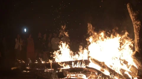 People jump over a large fire at the Festival of Russian traditions Stock Footage 66784782
