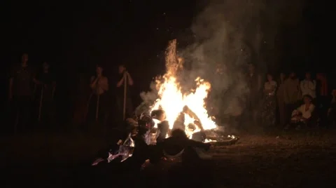 People jump over a large fire at the Festival of Russian traditions Stock Footage 66784798