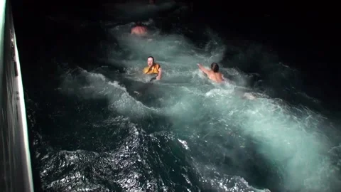 People jump into sea at night from deck ... | Stock Video | Pond5