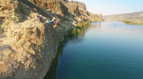 People jumping off the cliff Stock Footage 65966914