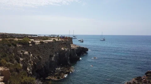 People jumping off cliffs on the island of tabarca Stock Footage 122219472