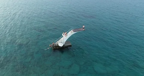 People jumping from diving board and swimming. Stock Footage 111280673