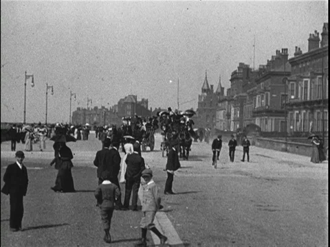 People jumping down from carriage, walking into house, watched by citizen, 1902 Stock Footage 136682066