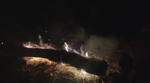 PEOPLE JUMPING OVER THE CAMPFIRE Stock Footage 68906755