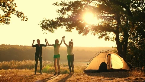 People jumping at sunset Stock Footage 108272996