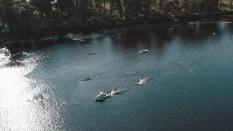 People kayaking and wake boarding with fast boats on the river Stock Footage 127247553
