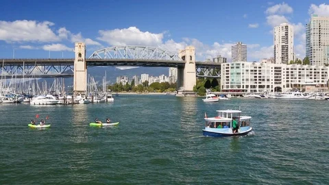 People kayaking with Burrard Bridge, Vancouver, BC, city waterfront travel HD Stock Footage