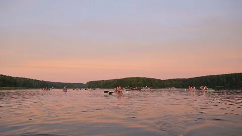 People in kayaking on Lake at sunset Stock-Footage 80093604