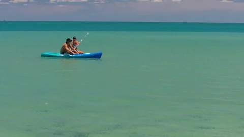 People kayaking on the ocean Stock Footage 90890769