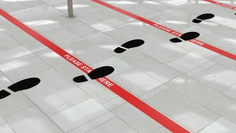 People keep distance at queue lines in the public places, airports and stores Stock Footage 134629298