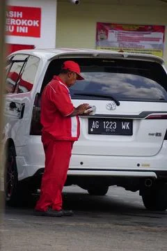 People keep on queue buy gasoline in Indonesian Stock Photos