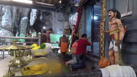 People kneeling for praying inside Hindu Temple, Main cave, Batu caves, Malaysia Видео 196380186