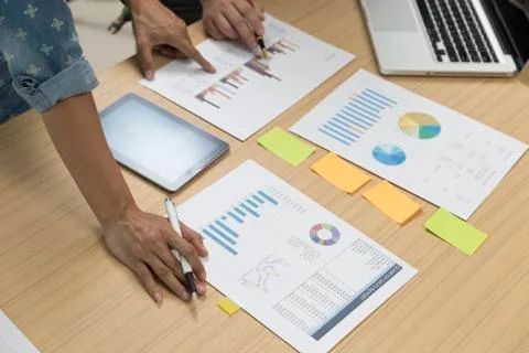 People with laptop computer, document, pen, digital tablet on desk Stock Photos