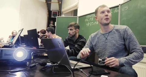 People with laptops communicating in classroom Video stock 82102853