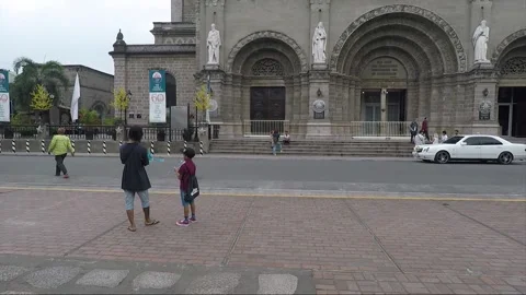 People launch Mechanical Flying Bird Toy, Square at Manila Cathedral, Intramuros Stock Footage 204058385