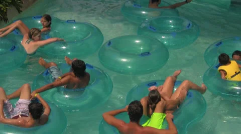 People on Lazy River Tubes Floating-by at Water Park Video stock 25890507