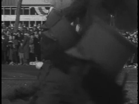 People lean out of their windows to watch baton twirlers and a US Navy marchingƒ Stock Footage 75276761