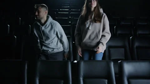 People leave the cinema. The end of the session. Couple after watching a movie Видео 267588930