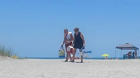 People leaving the beach Stock Footage 156415729