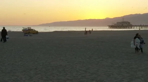 People Leaving the Beach at Sunset Stock Footage 10903032