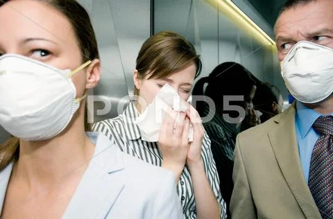 People In A Lift During A Health Alert