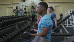 People In The Gym Lifting Dumbbells - Stock Video