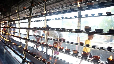 People lighting candles for prayers outside Temple of Tooth in Kandy, Sri Lanka Stock Footage 83622892