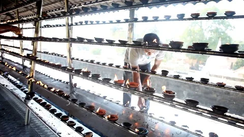 People lighting candles for prayers outside Temple of Tooth in Kandy, Sri Lanka Stock Footage 83623314