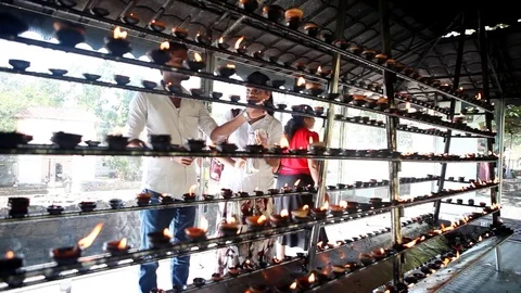 People lighting candles for prayers outside Temple of Tooth in Kandy, Sri Lanka Stock Footage 83624472