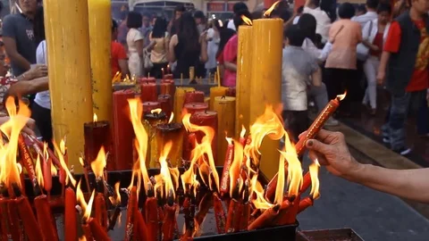People lights candles before offering prayers. Stock Footage 72426420