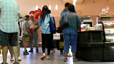 People line up for buying bread inside Maxim's bakery Stock Footage 65798375